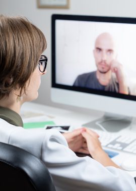 Digital health concept: practicing physician having online appointment with a patient. Medical doctor consulting a person by means of web conference system